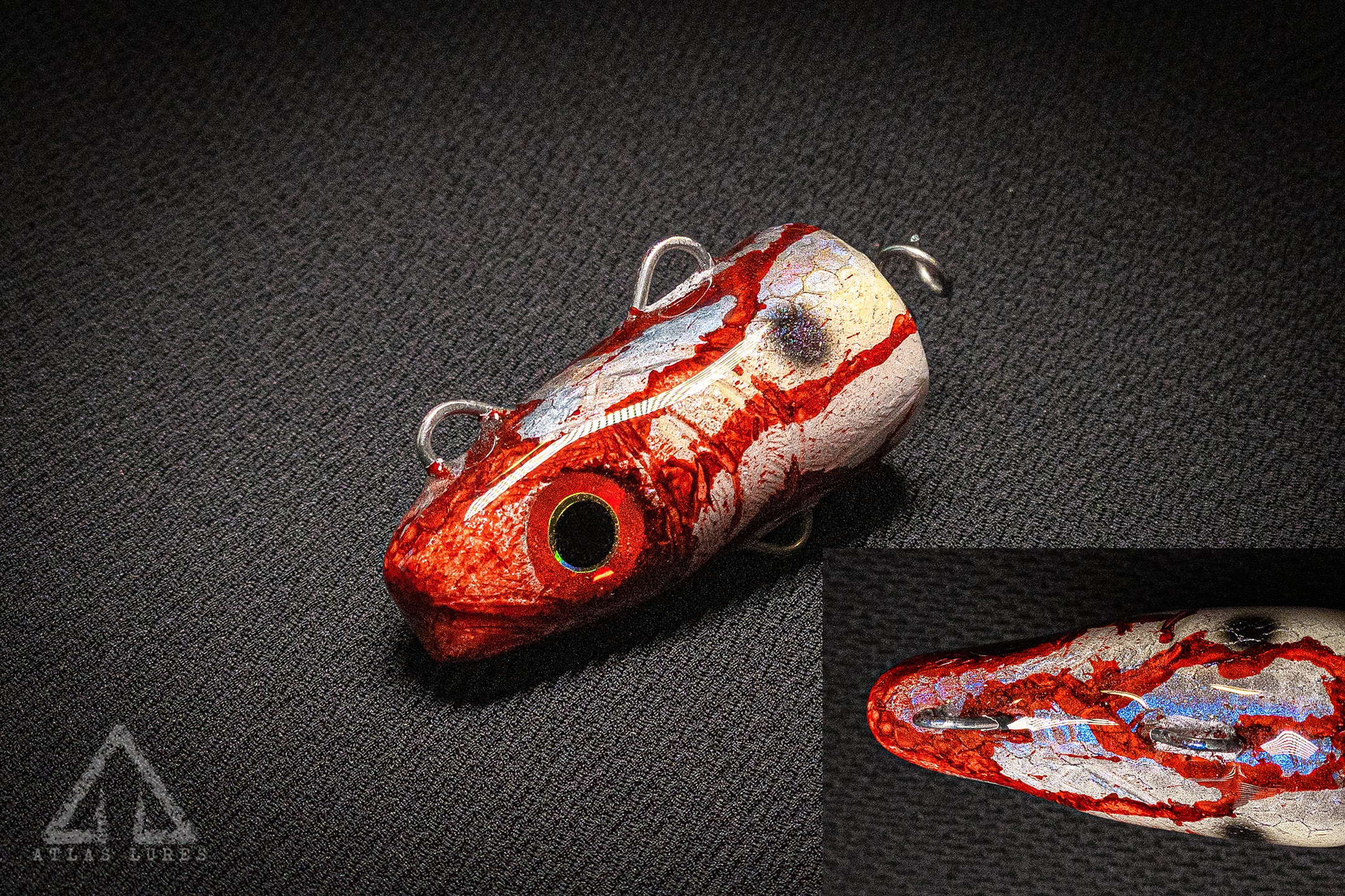 Red and white fishing lure on a dark textured background