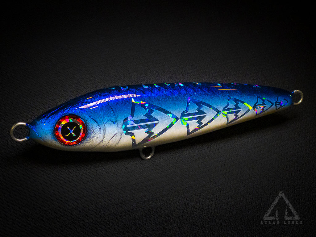 Blue and white fishing lure with a dark background