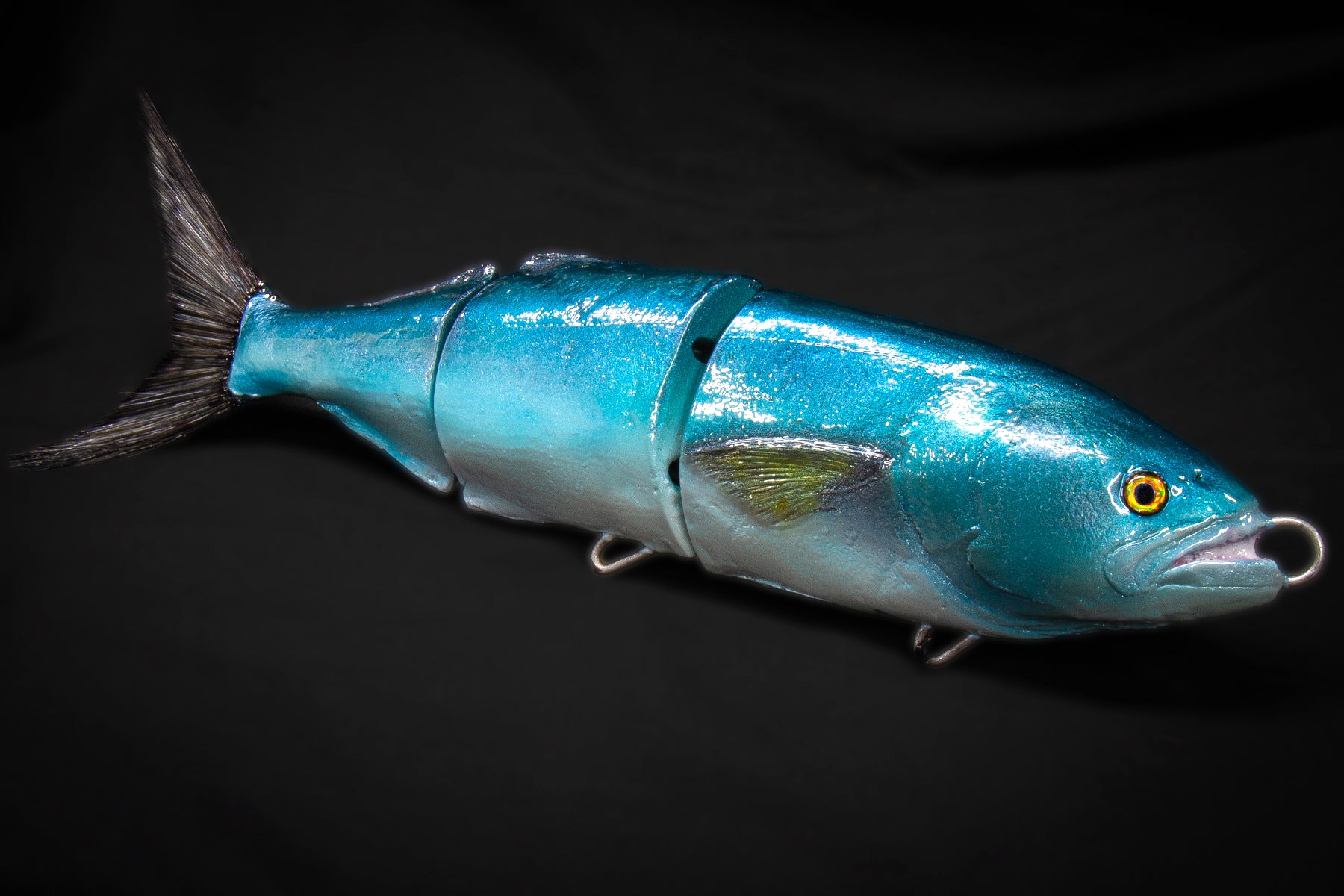 Blue fishing lure on a black background