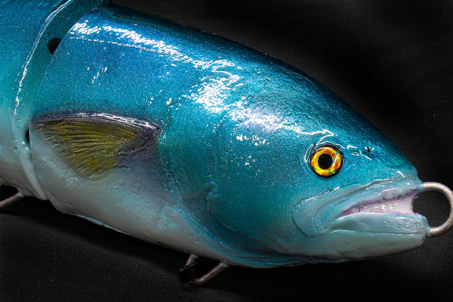 Blue fishing lure with a detailed head on a black background