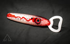 Bottle opener with red and white design on a dark background