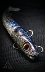 Fishing lure with metallic finish on a dark textured background