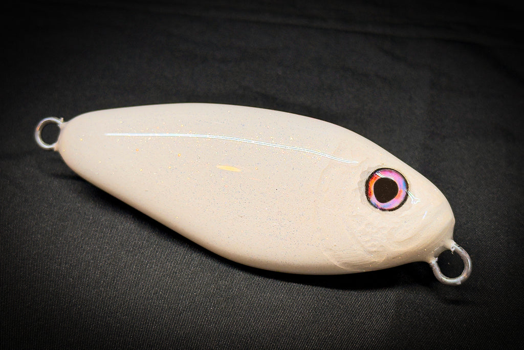 White fishing lure with a black background