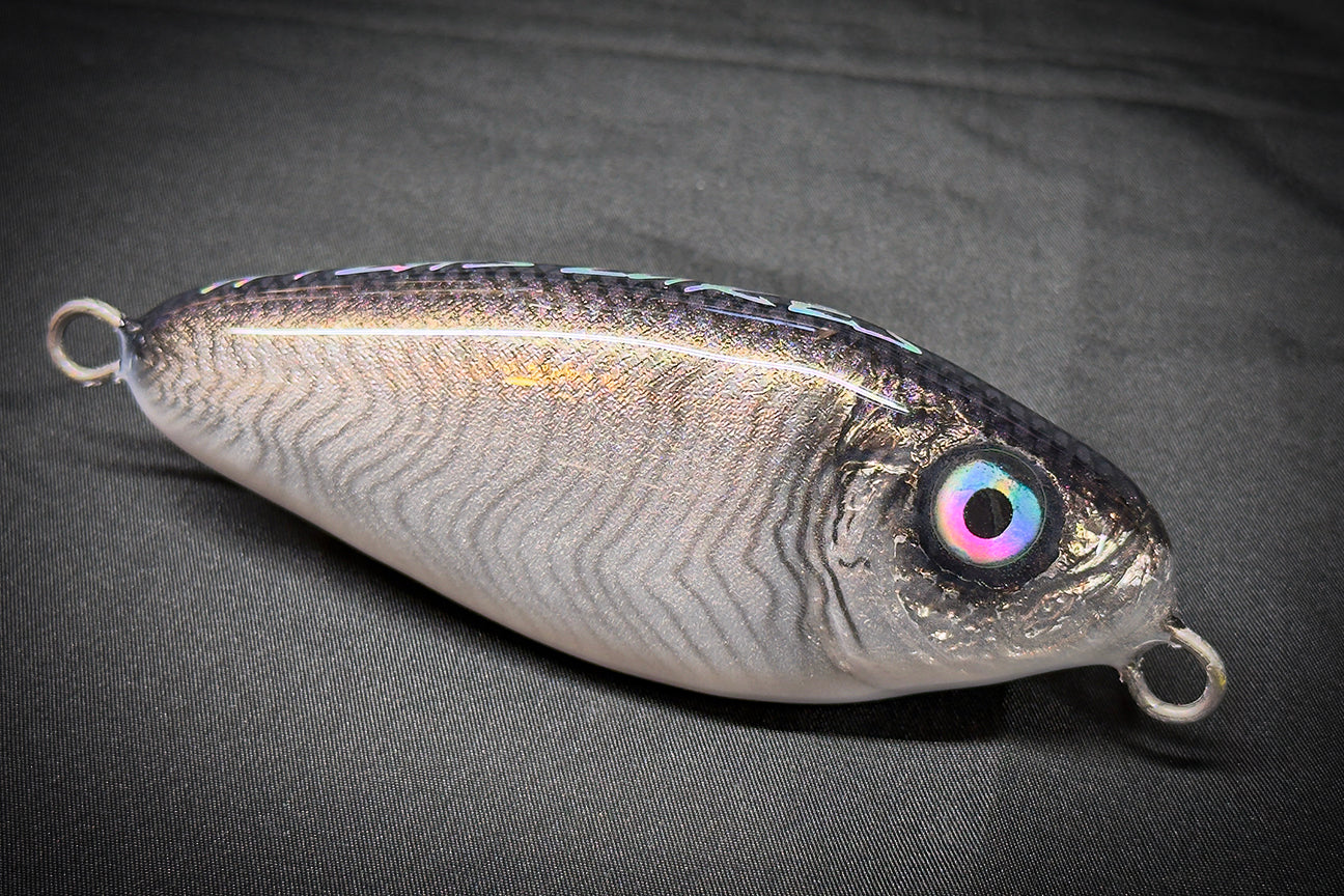 Fishing lure with metallic finish and colorful eye on a gray background. Handmade in US