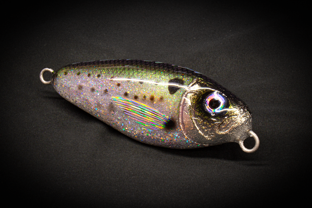 Hand Poured Resin Fishing lure with metallic and speckled design on a black background. 