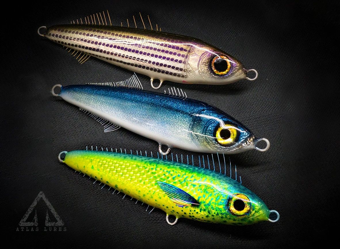 Three colorful fishing lures on a dark background