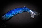 Blue and clear glittery object on a dark background