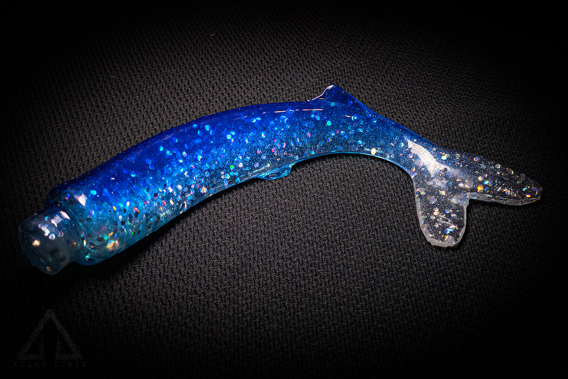 Blue and clear glittery object on a dark background