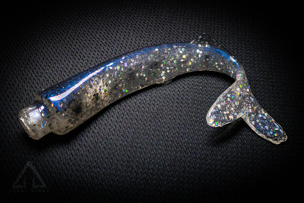 Shiny metallic object on a textured black background