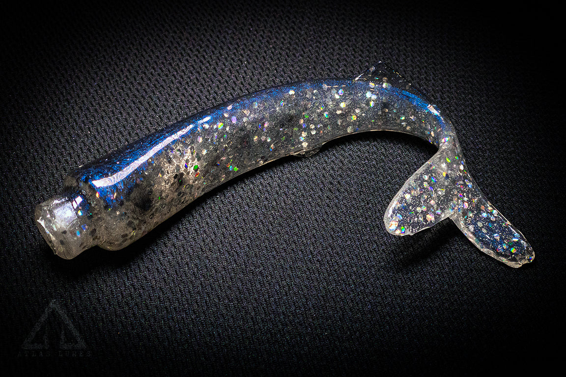 Shiny metallic object on a textured black background