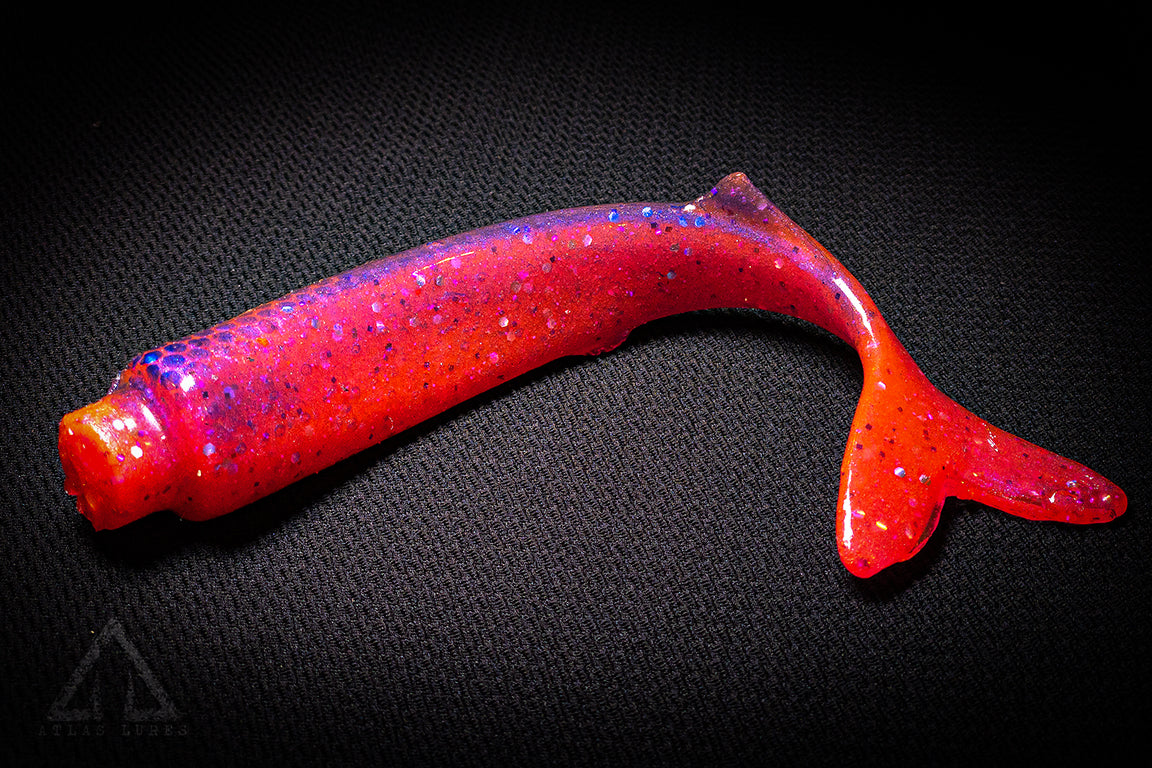 Red fishing lure with a black background