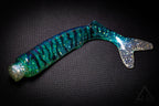 Blue and green glittery fishing lure on a black background