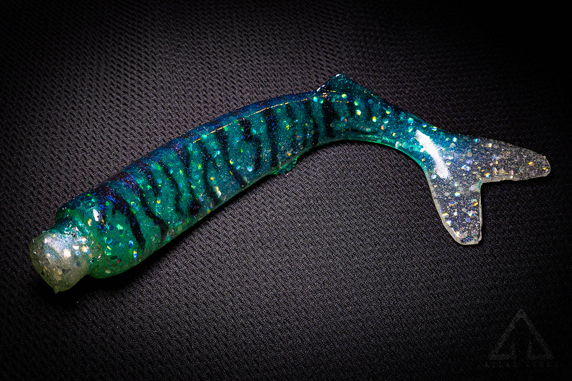 Blue and green glittery fishing lure on a black background