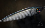 Metallic fishing lure on a dark background