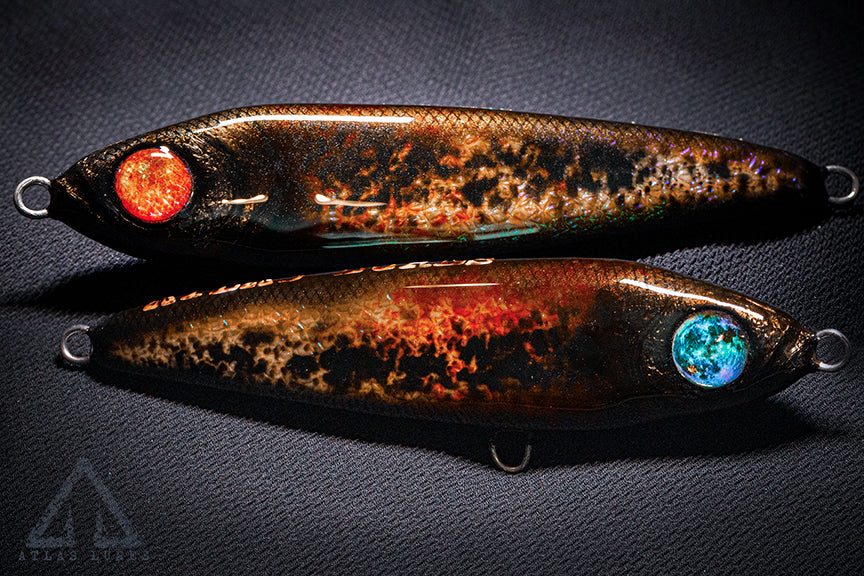 Two fishing lures with glowing eyes on a dark background. Handmade in USA