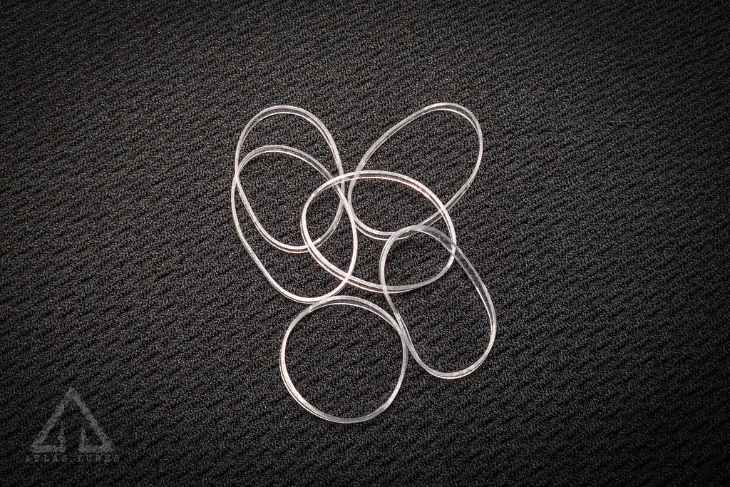 Silver metal rings on a textured black surface