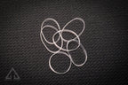 Silver metal rings on a textured black surface
