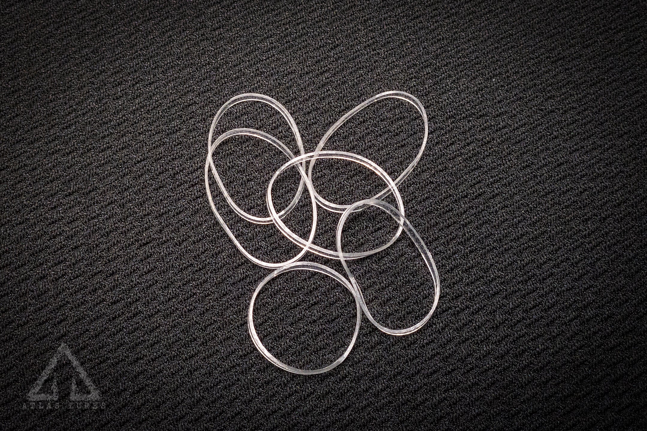 Silver metal rings on a textured black surface