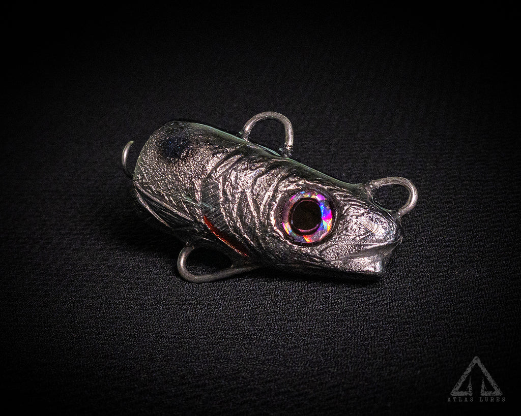 Metallic fishing lure on a black background