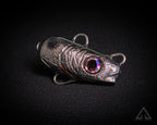 Metallic fishing lure on a black background