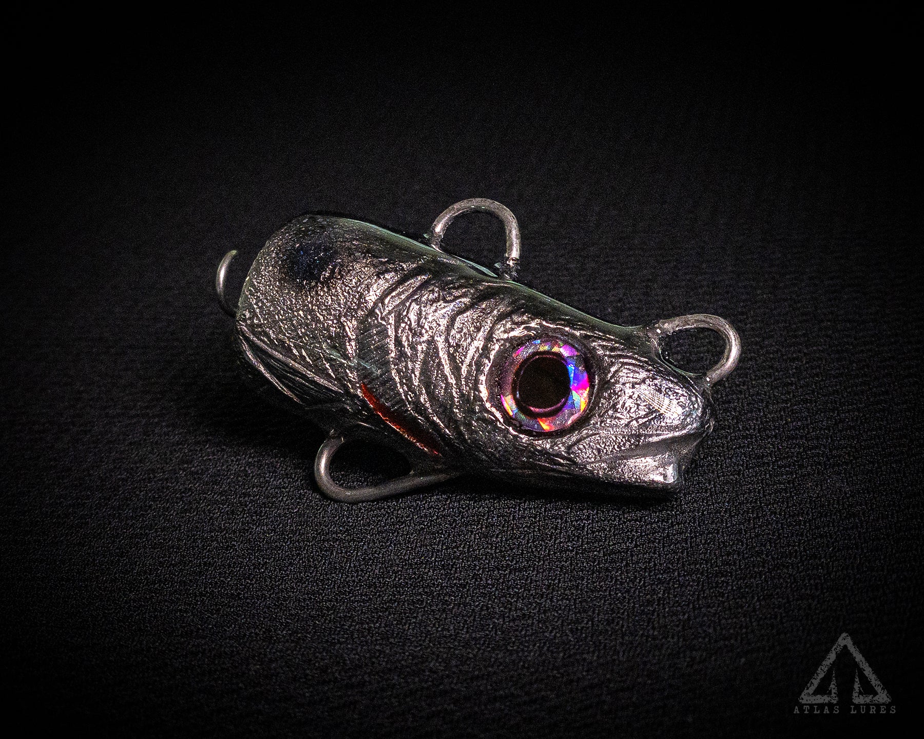 Metallic fishing lure on a black background