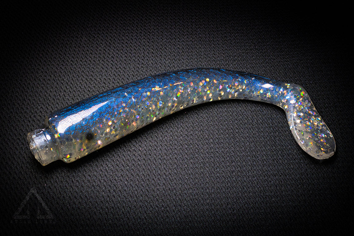 Blue and silver glitter fishing lure on a dark textured background