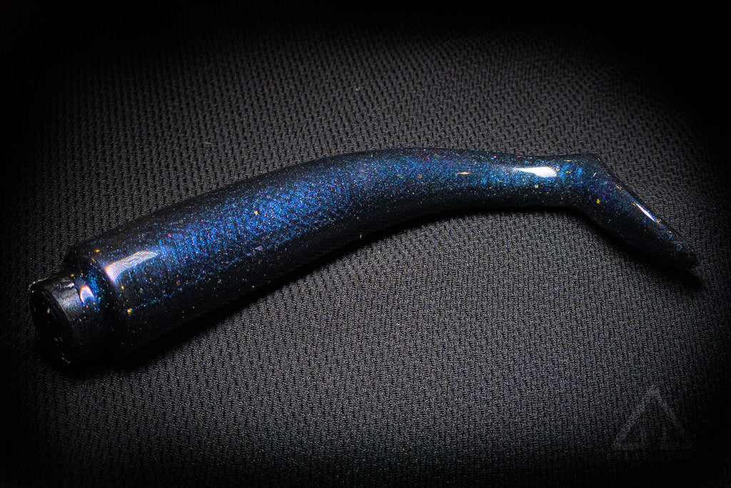 Blue glittery fishing lure on a dark textured background