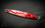 Hand poured resin blood and white fishing lure on a dark background