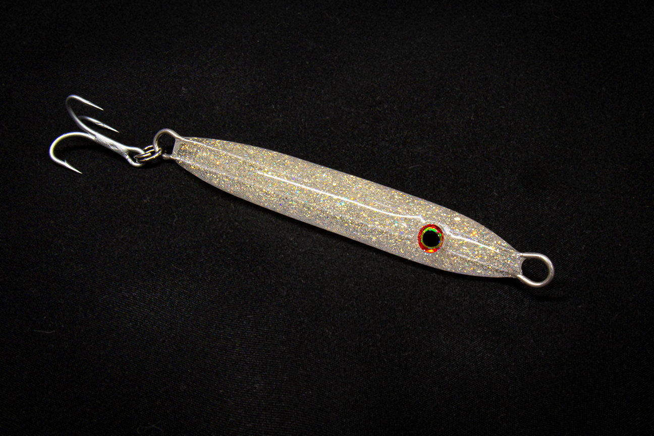 Metallic fishing lure with a hook on a black background