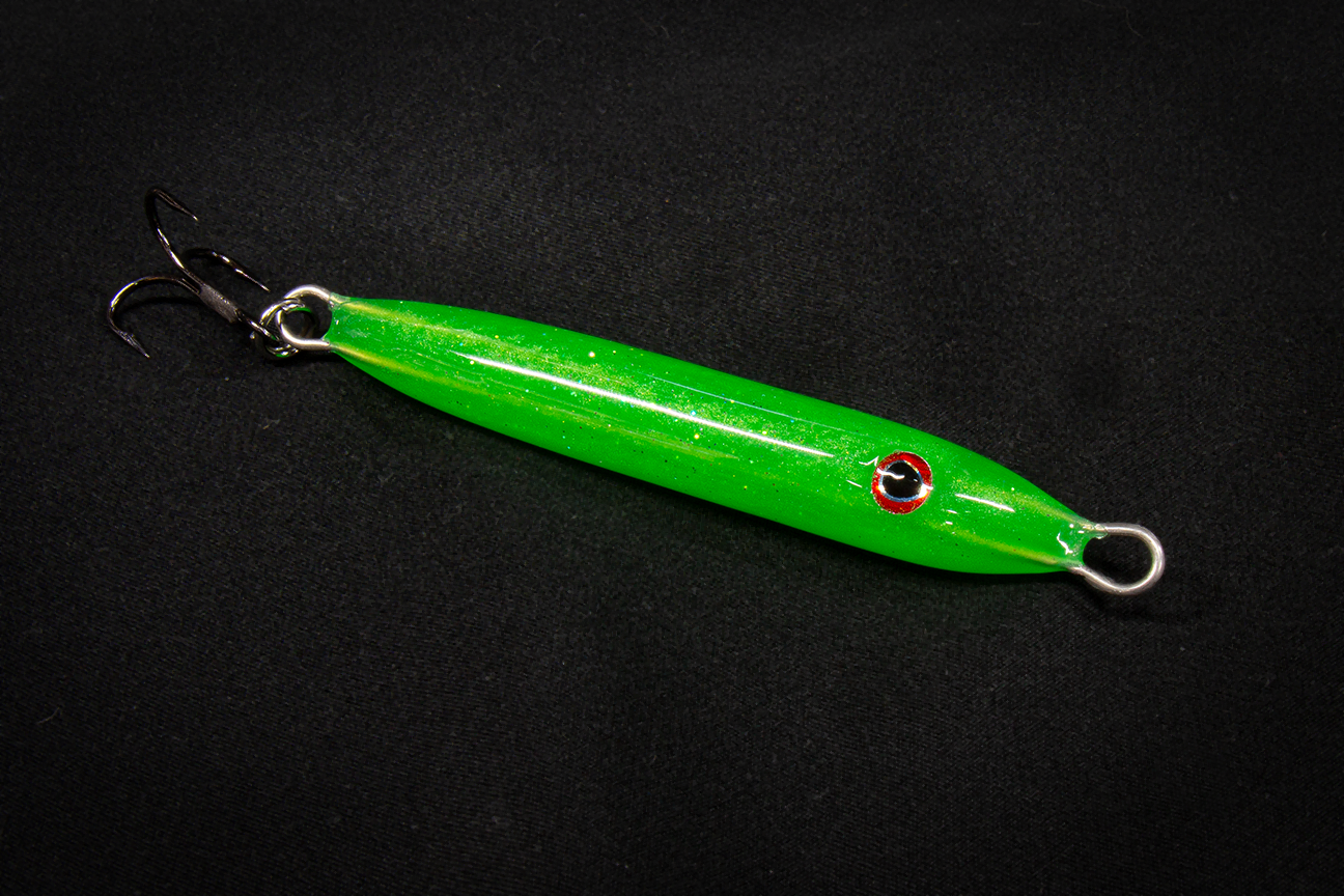 Hand poured resin Green fishing lure on a black background