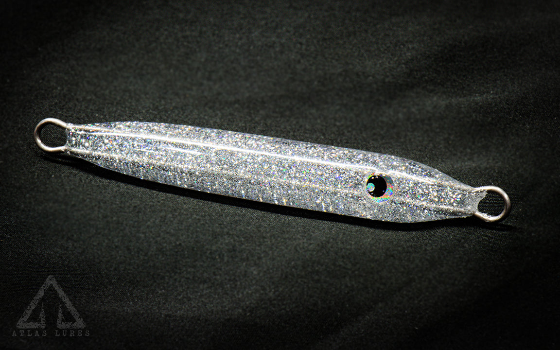 Metallic fishing lure on a black background