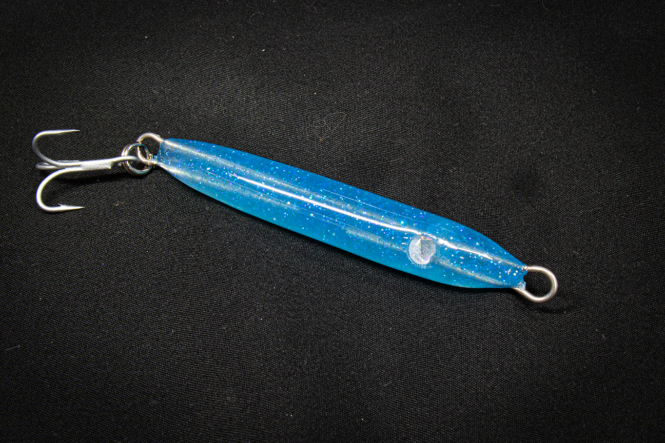 HAND POURED RESIN Blue fishing lure with a hook on a black background