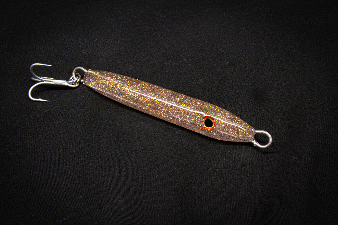 Metallic fishing lure on a black background