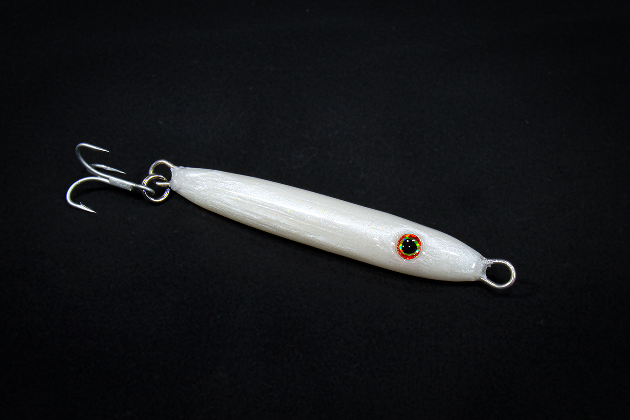 White fishing lure with a hook on a black background. Handmade in USA