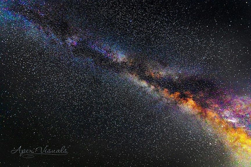 Colorful galaxy image with star-studded sky, credit to Apex Visuals.
