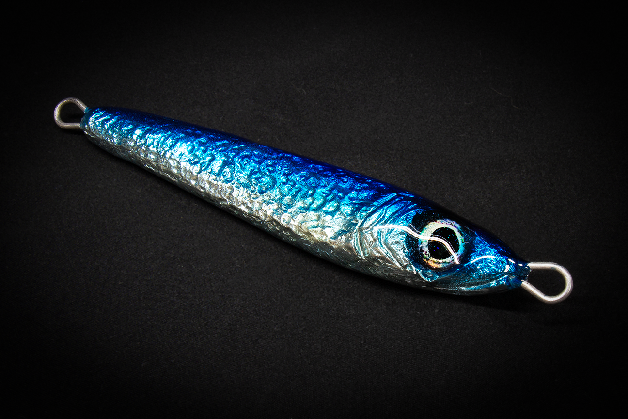 Hand poured resin Blue metallic fishing lure on a black background