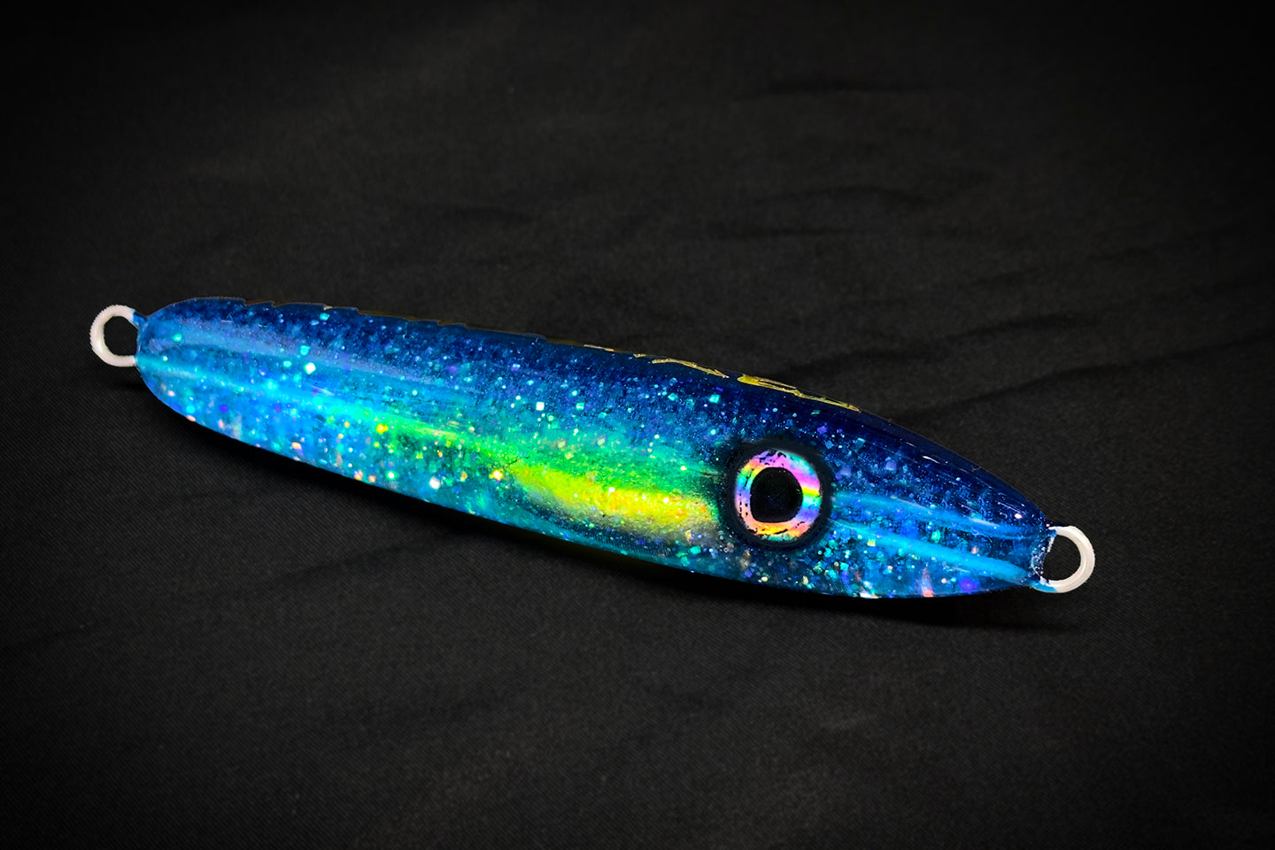 Blue and green fishing lure on a black background handmade