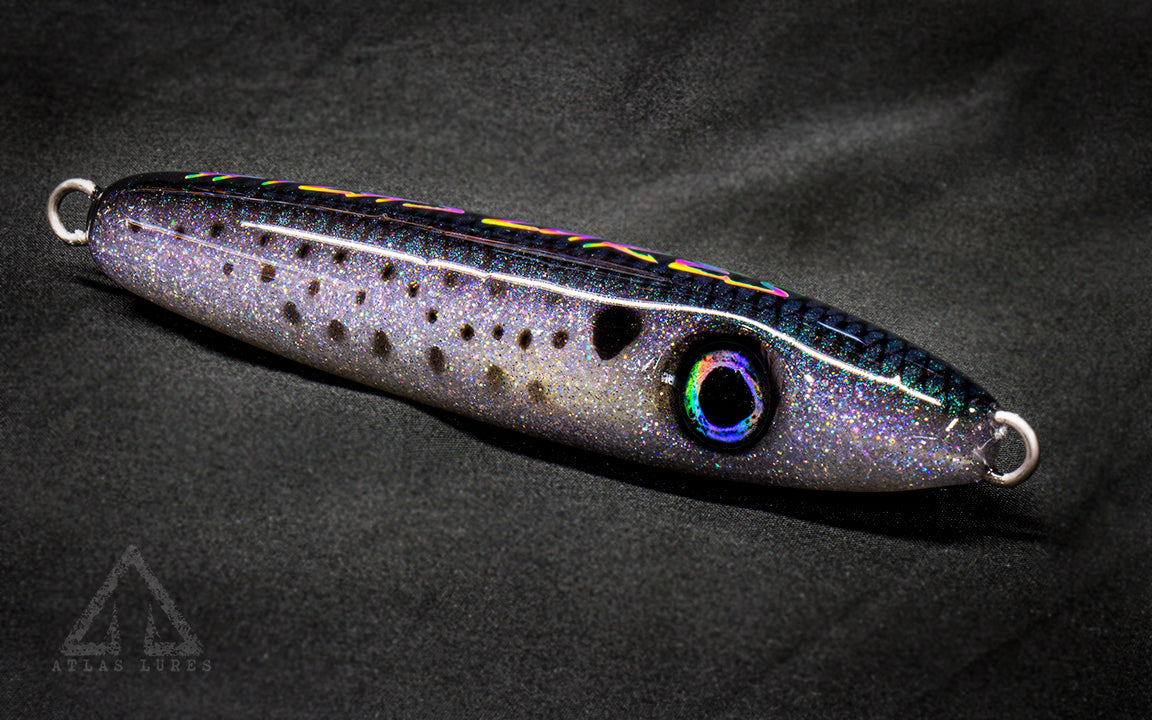 Fishing lure with metallic sheen on a dark background
