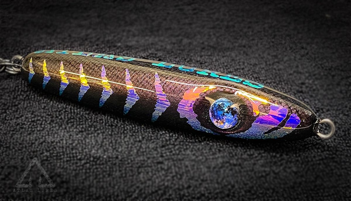 Colorful fishing lure with iridescent finish on a dark background